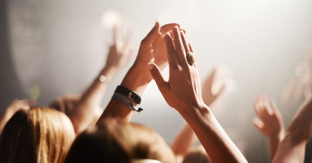 Arena concert vs small venue representing income inequality in live music industry