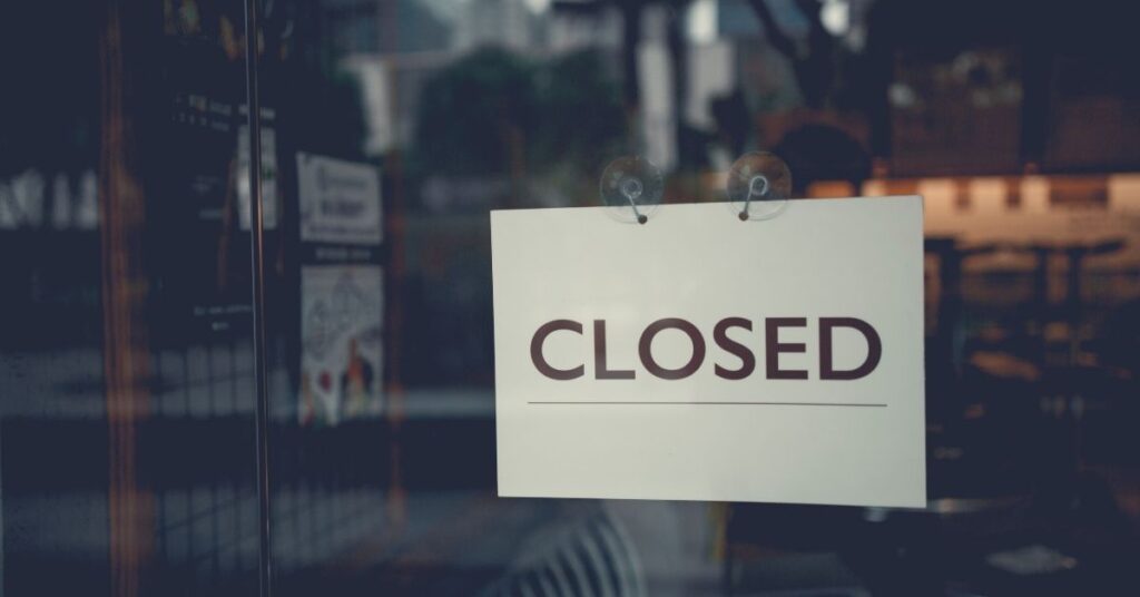 Closed grassroots venue with posters of famous bands showing impact of rising costs in live music 2026