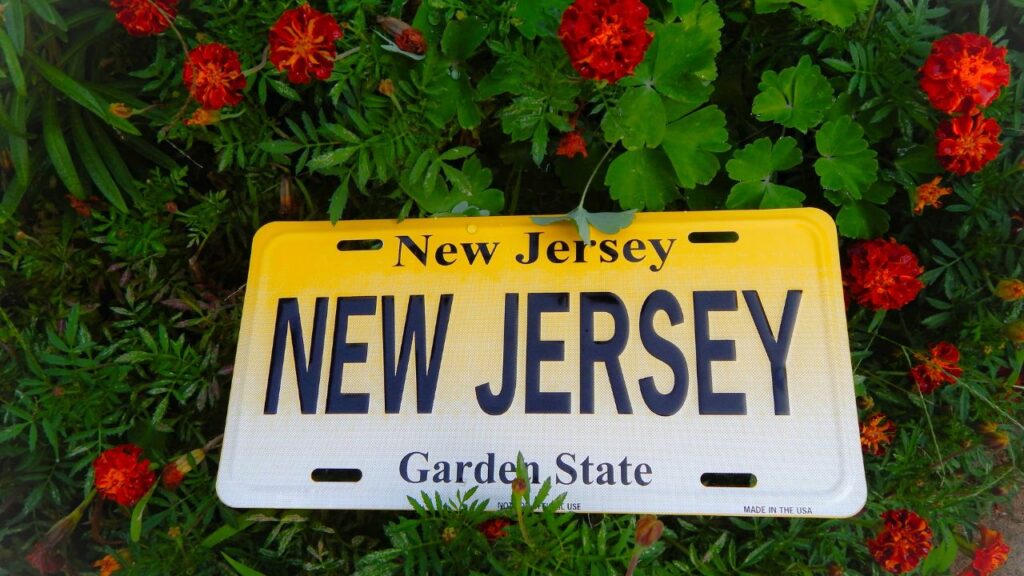 New Jersey rock and metal bands working with a UK publicist to plan a music PR campaign, featuring laptops, press kits, and band posters — symbolizing global rock publicity and cross-Atlantic media promotion.